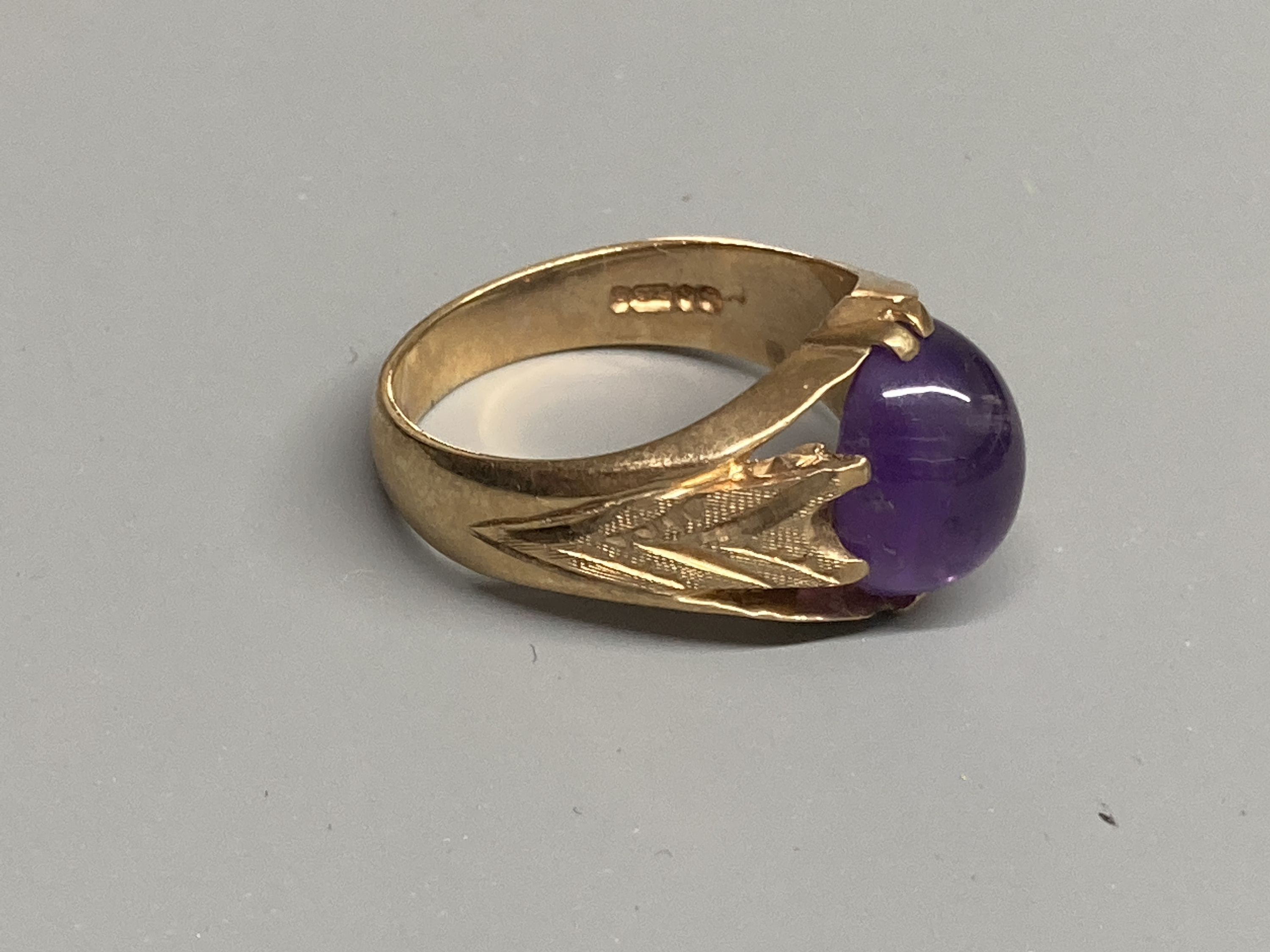 Two modern 9ct gold and cabochon amethyst set dress rings, sizes Q/R & T